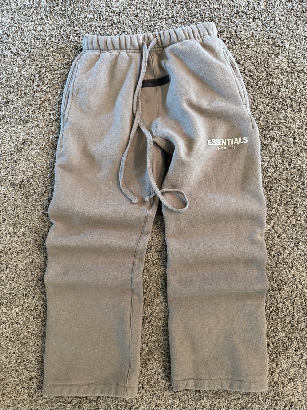 Fear of God ESSENTIALS sweatpants in taupe with black patch and white logo